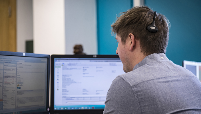 man sitting at computer