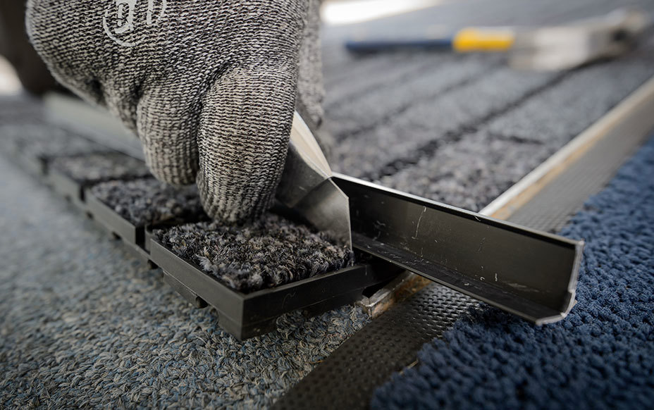 Commercial entrance mat being fitted by phs employee