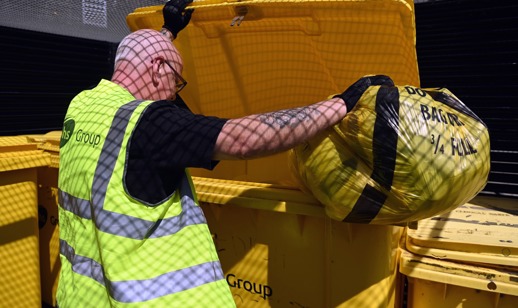 A Tiger bag containing offensive waste being disposed of