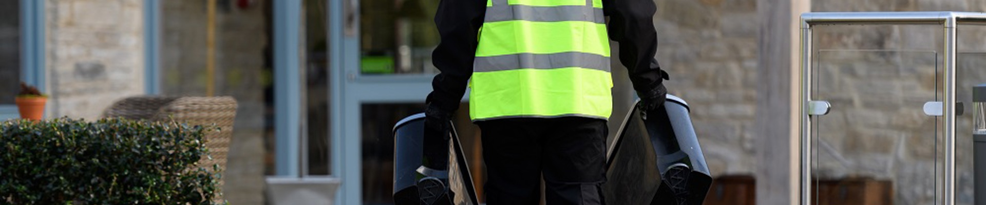 phs worker carrying sanitary bins