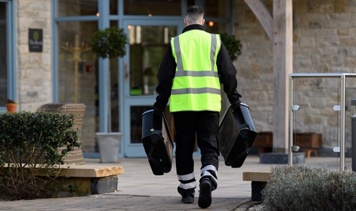 phs worker carrying sanitary bins